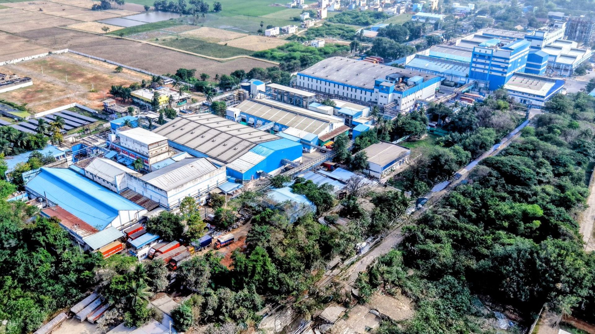 Hindistan’ın Pondicherry kentinde bulunan Unilever Evde Bakım ürünleri fabrikasının havadan görünümü; mavi ve beyaza boyanmış büyük endüstriyel binalardan oluşan bir kompleks.